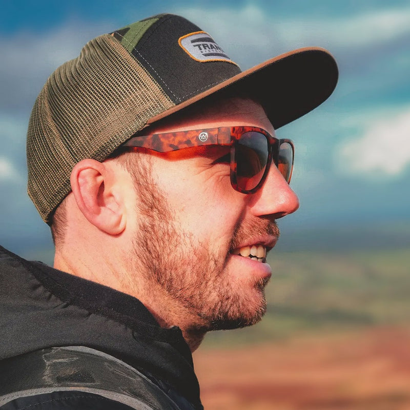 Photograph of a man hiking wearing Odyssey Activewear Hybrid Sunglasses