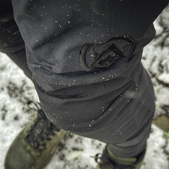 Close up of Odyssey Activewear Shield Trousers embroidered logo with snow flakes