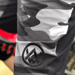 Load image into Gallery viewer, Odyssey Activewear Dark Camo Shield Shorts logo detail