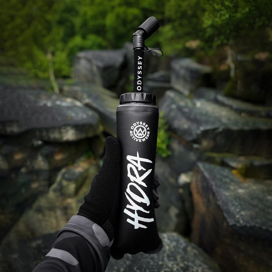 Odyssey Activewear Hydra soft flask being held while climbing rocks