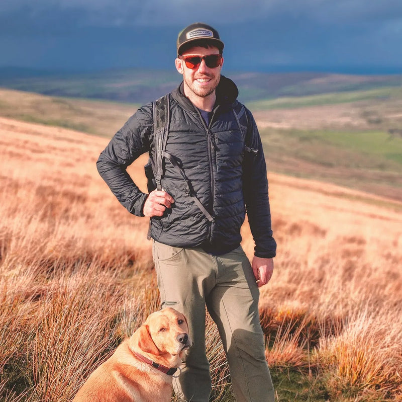 Man hiking with dog wearing Odyssey Activewear Hybrid Sunglasses