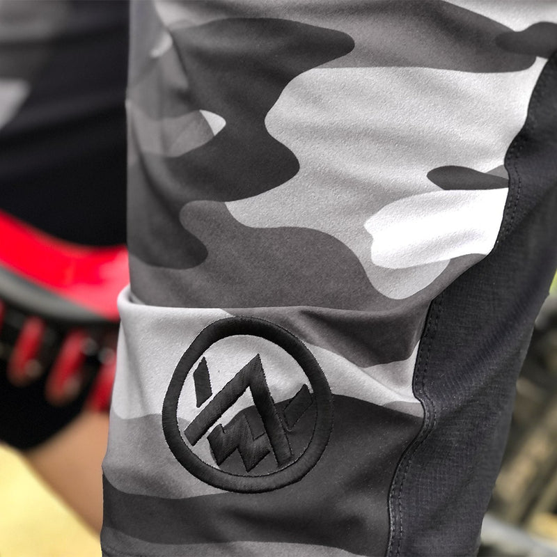 Embroidered logo detail on the Odyssey Activewear Camo MTB Shorts