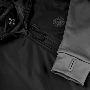 Close up detail shot of the Odyssey Activewear Noir Black Transition Tech Hoodie showing the chest accessory pocket and thumb holes