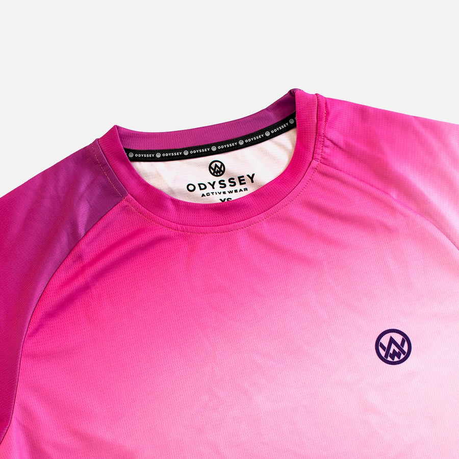 Detail shot of the Odyssey Activewear Spectrum Dusk jersey showing the breathable, quick-drying fabric and pink & purple colour scheme