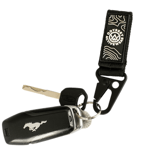 Black Odyssey Activewear Multi-Purpose Snap Hook Strap used as a keychain
