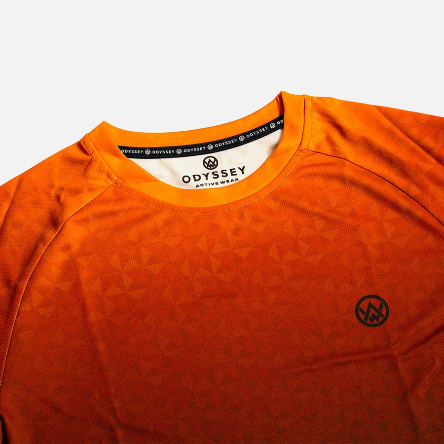 Detail shot of the Odyssey Activewear Triangulation Molten T-shirt showing the breathable, quick-drying fabric and orange triangle pattern