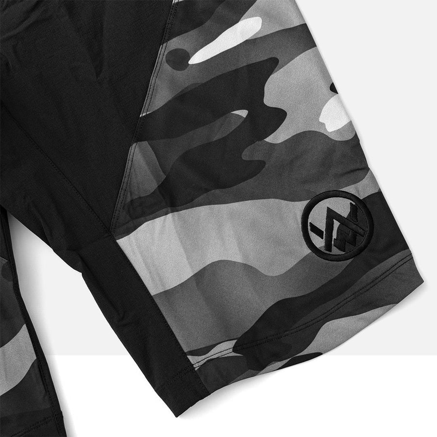 Front leg shot of the Odyssey Activewear Camo Shield Shorts showing the embroidered logo