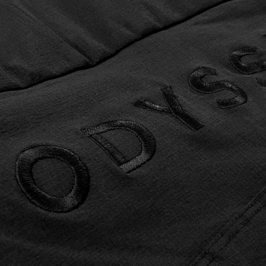 Detail shot of the logo embroidery on the rear of the Odyssey Activewear Shield Shorts